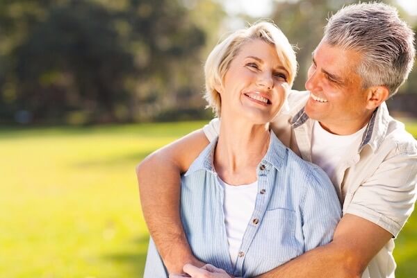 couple smiling after receiving dental treatment